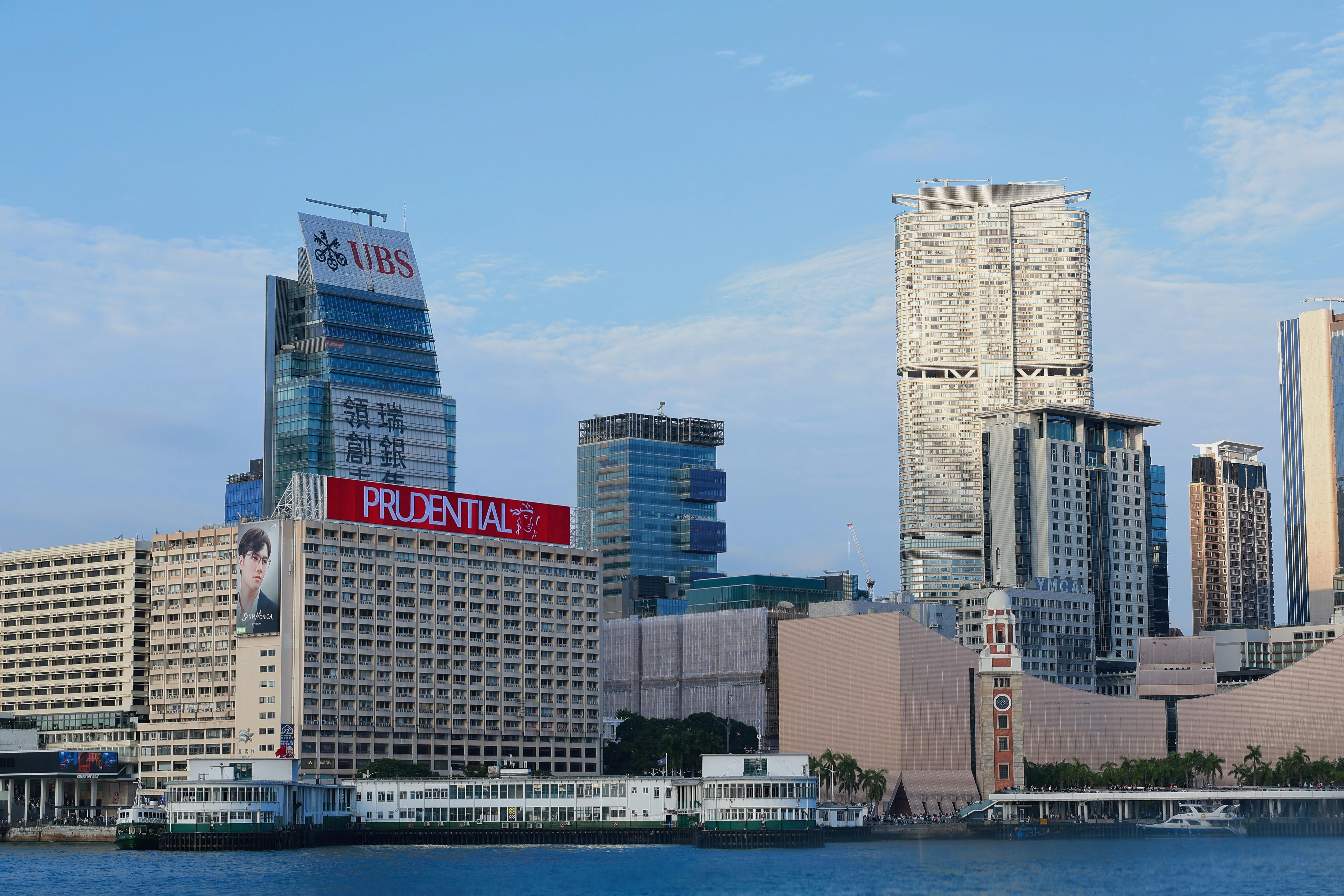 Hong Kong skyline with modern architecture near the waterfront.
