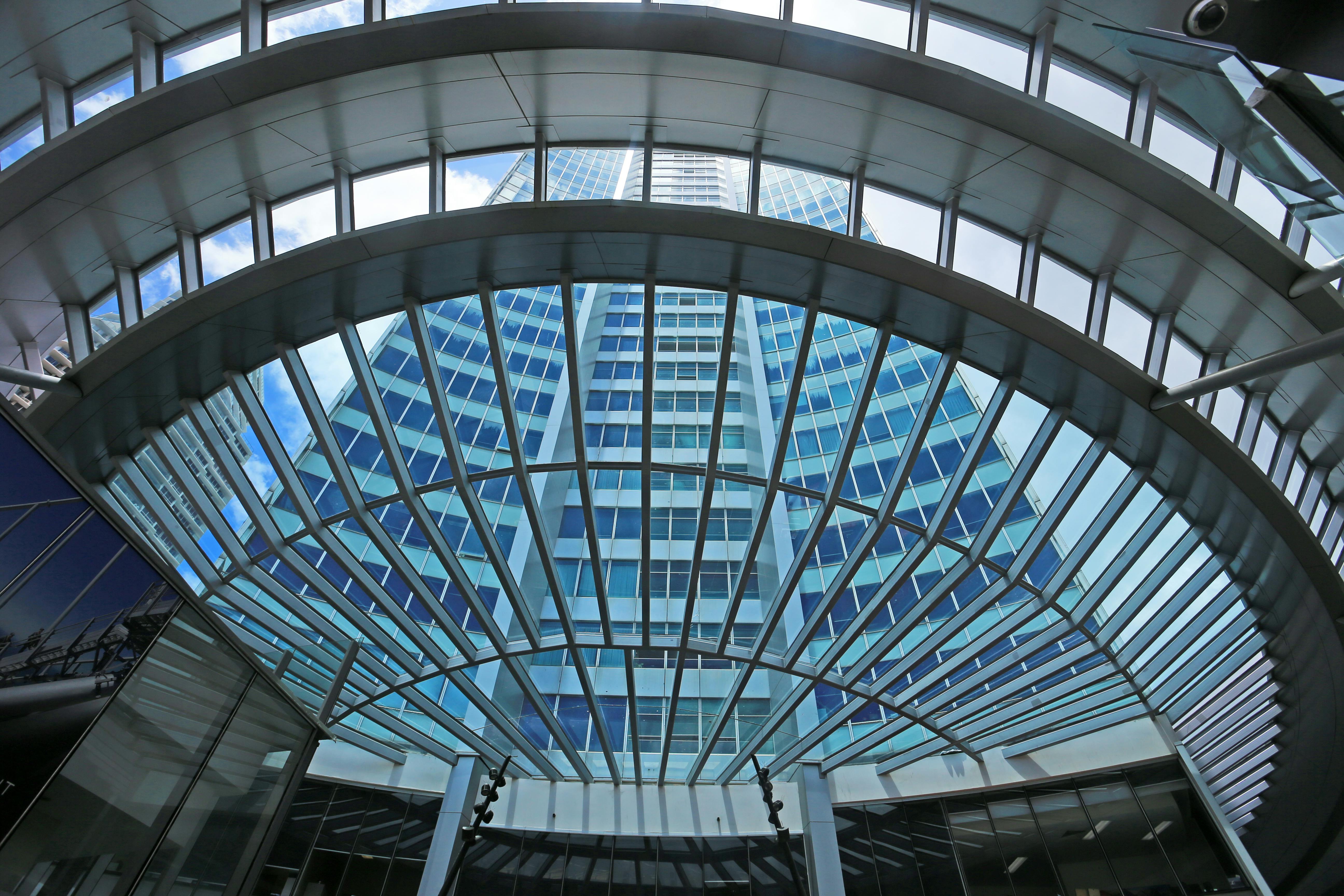 Modern glass corporate building framed through a structural canopy.